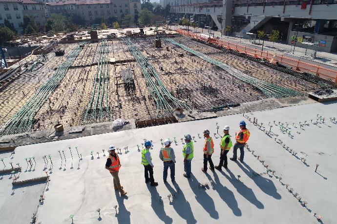 seven construction workers standing on white field